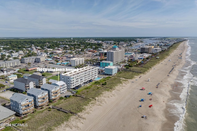 birds eye view of property with a water view and a view of the beach