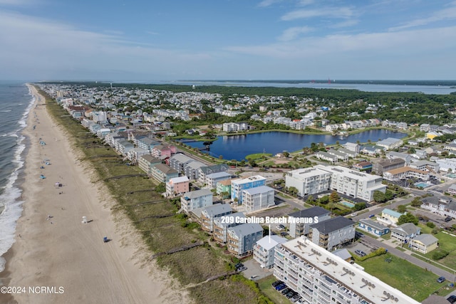 aerial view with a water view and a view of the beach