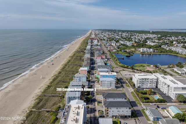 drone / aerial view with a water view and a view of the beach