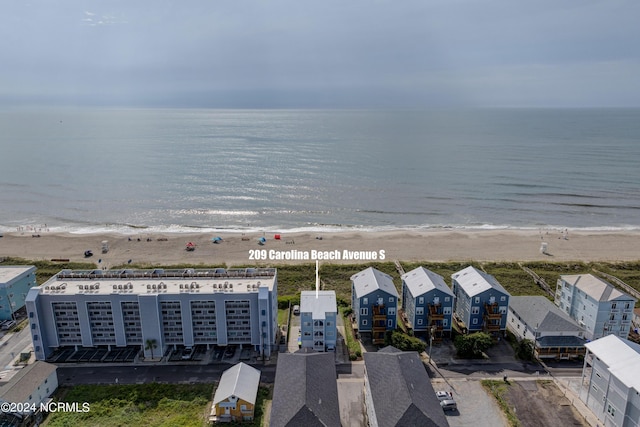 drone / aerial view featuring a water view and a beach view