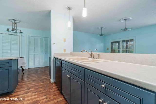 kitchen with pendant lighting, sink, dark wood-type flooring, and black dishwasher