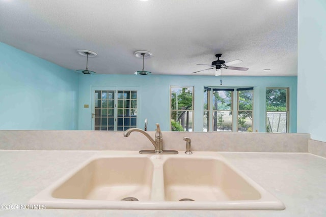 interior space with sink and a textured ceiling