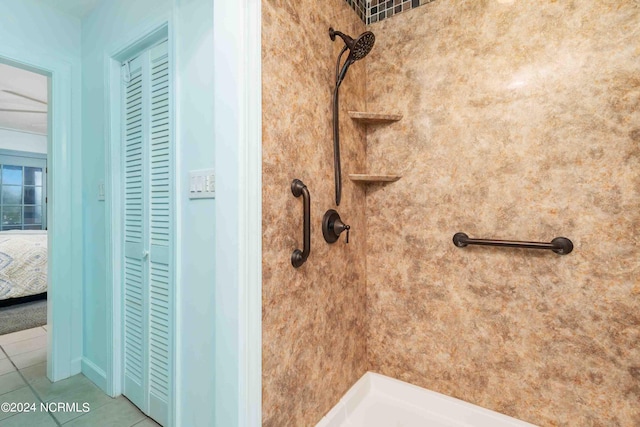 bathroom featuring tile patterned flooring and tiled shower