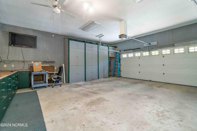 garage featuring a garage door opener and ceiling fan