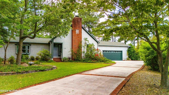 view of front of home with a garage and a front yard