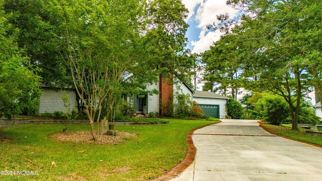 view of front of home featuring a garage and a front lawn