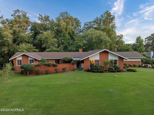 ranch-style home with a front lawn