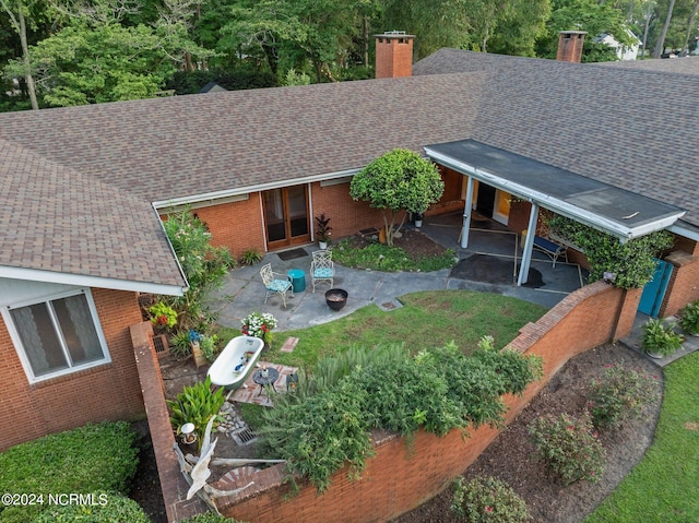 view of yard featuring an attached carport and a patio area