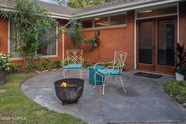 view of patio / terrace with an outdoor fire pit and french doors