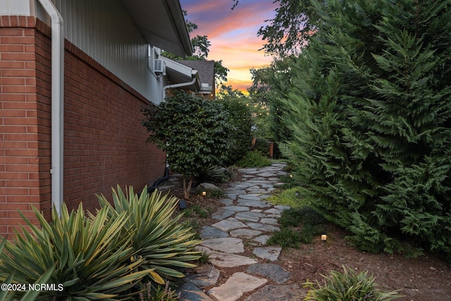 view of side of property featuring brick siding