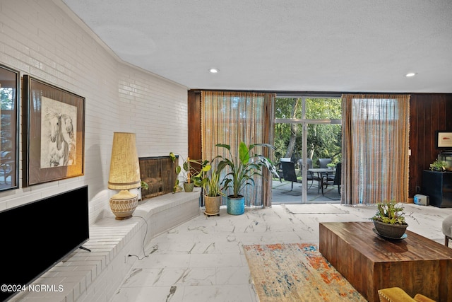 living room with recessed lighting, marble finish floor, and a textured ceiling