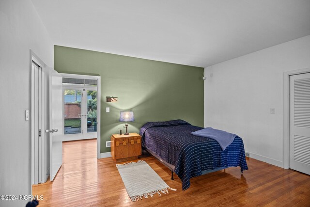 bedroom with baseboards and wood finished floors