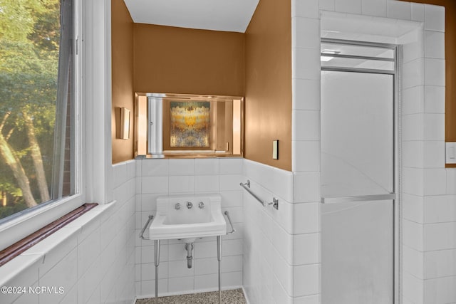 bathroom featuring wainscoting and tile walls