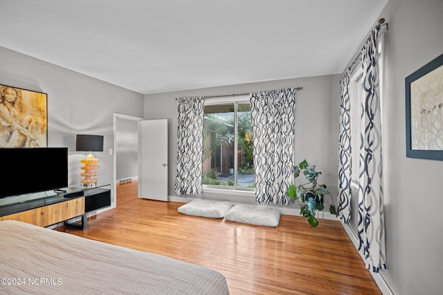 bedroom with baseboards and wood finished floors