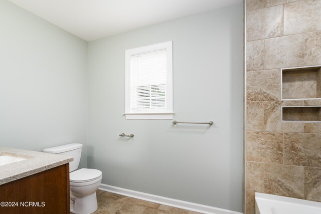 bathroom featuring tile patterned floors, toilet, and vanity