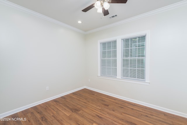 empty room featuring hardwood / wood-style flooring, ornamental molding, and ceiling fan