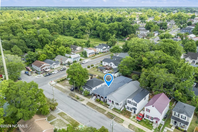 birds eye view of property featuring a residential view and a wooded view