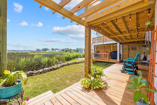 deck featuring area for grilling, a yard, and a pergola