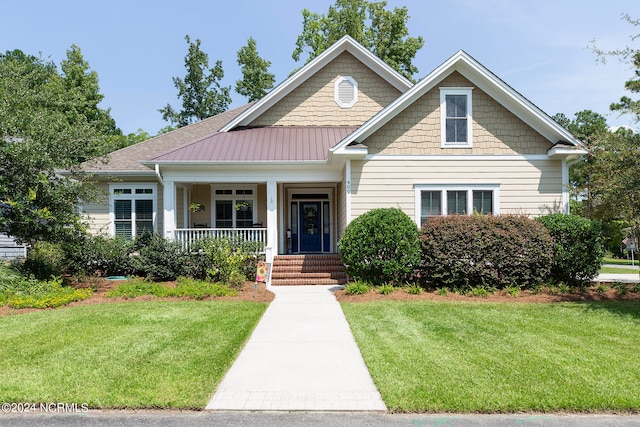 craftsman-style home with a front lawn and a porch