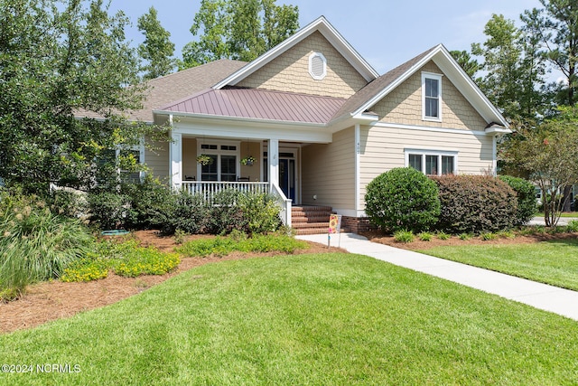 craftsman-style house featuring a front yard and a porch