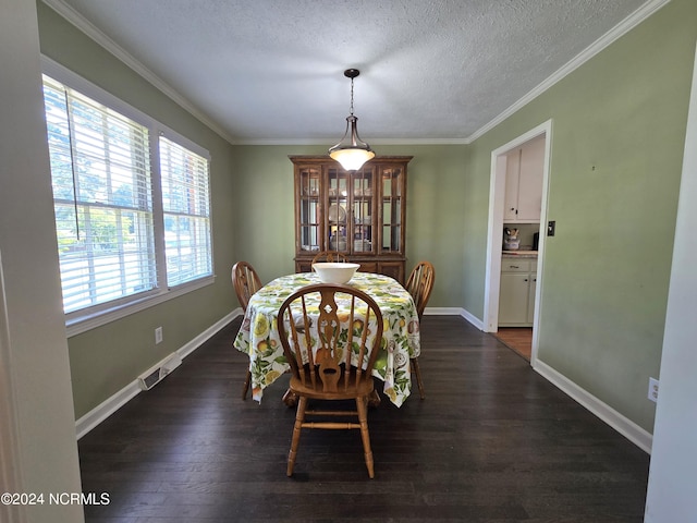 dining area with crown molding, dark hardwood / wood-style floors, and a textured ceiling