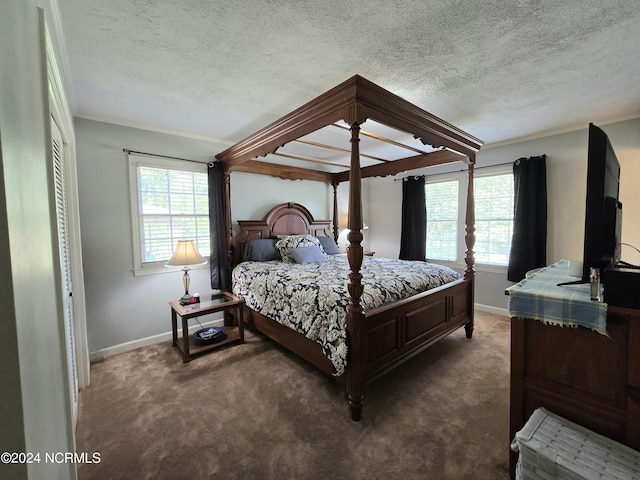 carpeted bedroom featuring crown molding and a textured ceiling