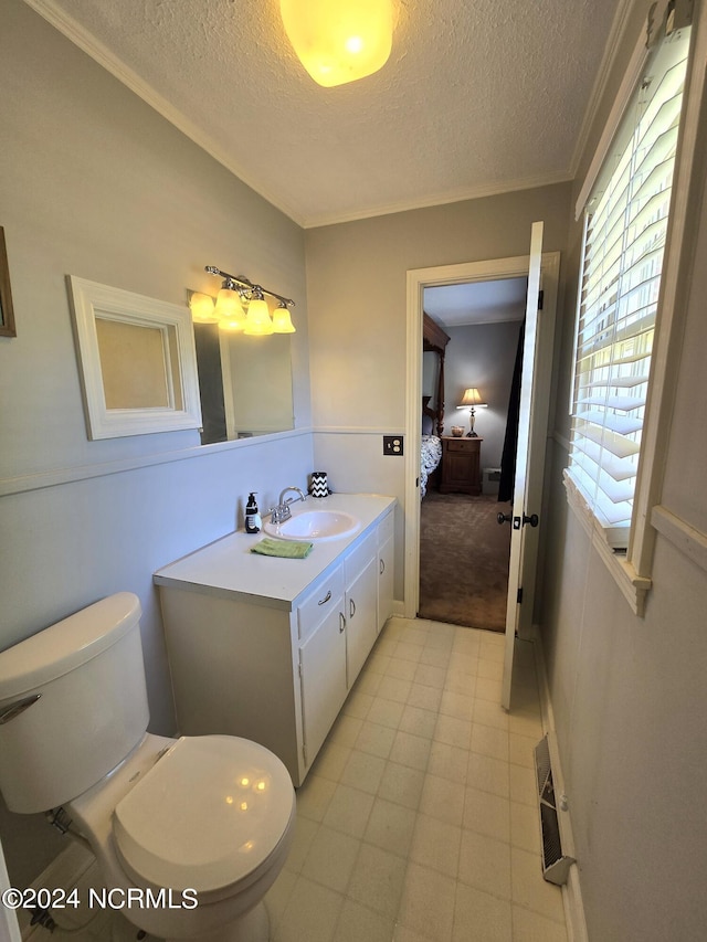 bathroom featuring vanity, a textured ceiling, and toilet