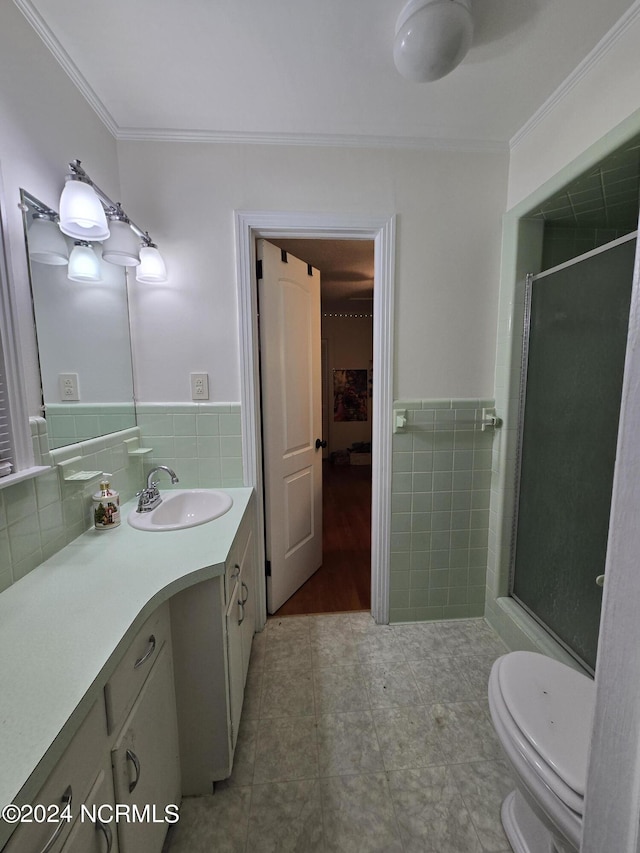 bathroom featuring crown molding, vanity, an enclosed shower, and tile walls