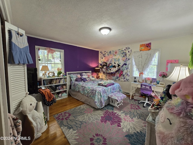 bedroom with wood-type flooring and a textured ceiling