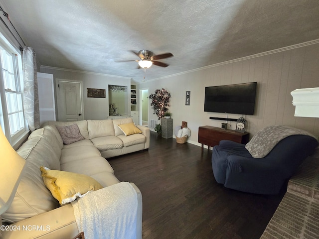 living room featuring dark wood-type flooring, ceiling fan, ornamental molding, and a textured ceiling