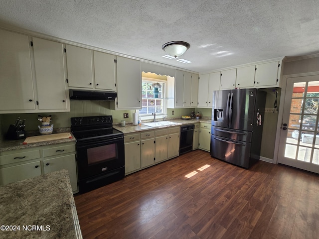 kitchen with dark wood-type flooring, a healthy amount of sunlight, sink, and black appliances