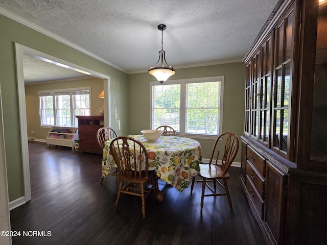 dining area featuring a healthy amount of sunlight, dark wood-type flooring, a textured ceiling, and crown molding