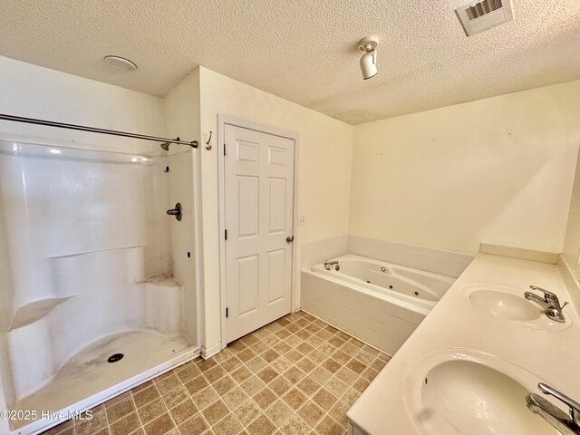 bathroom with vanity, toilet, and a textured ceiling