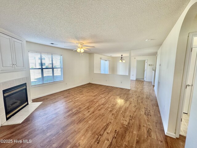 view of front of property with a balcony, central AC, and a front yard