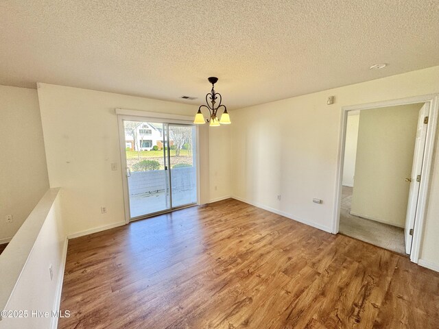 interior space featuring hardwood / wood-style flooring and a textured ceiling