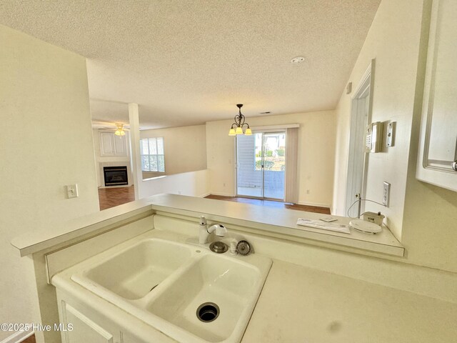 carpeted bedroom with ceiling fan and a textured ceiling