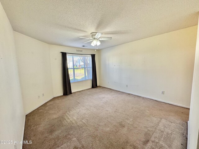 bedroom with ceiling fan, a spacious closet, and light carpet