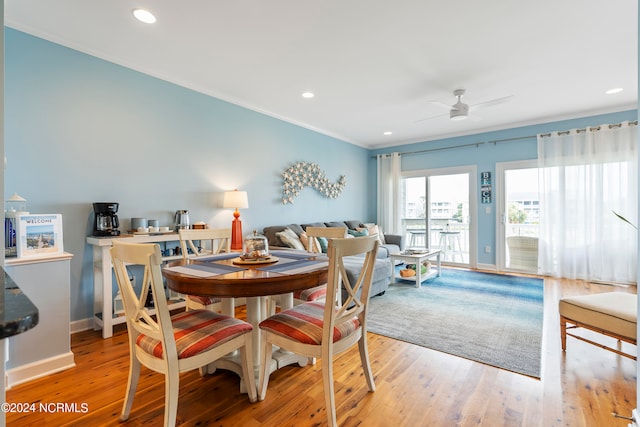 dining room featuring crown molding, light wood-type flooring, and ceiling fan