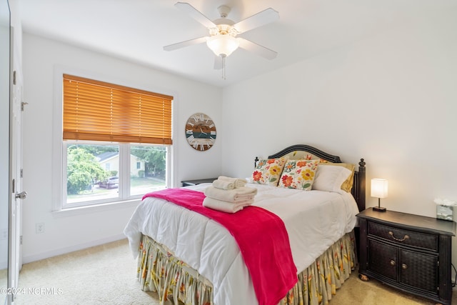 bedroom with light colored carpet and ceiling fan