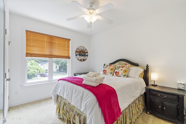 bedroom featuring ceiling fan and light colored carpet