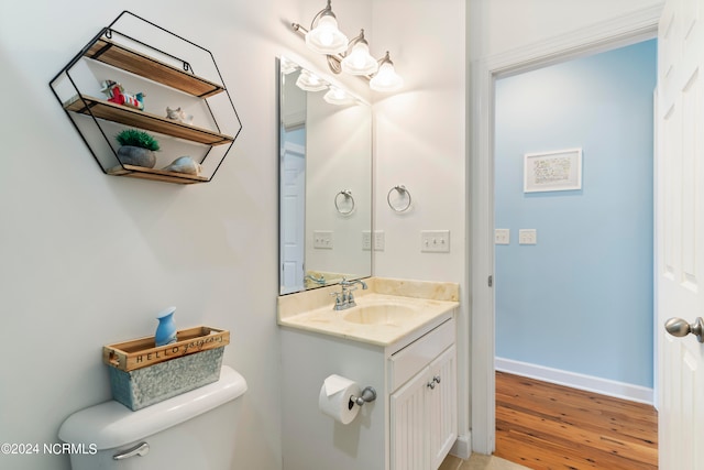 bathroom featuring hardwood / wood-style floors, vanity, and toilet