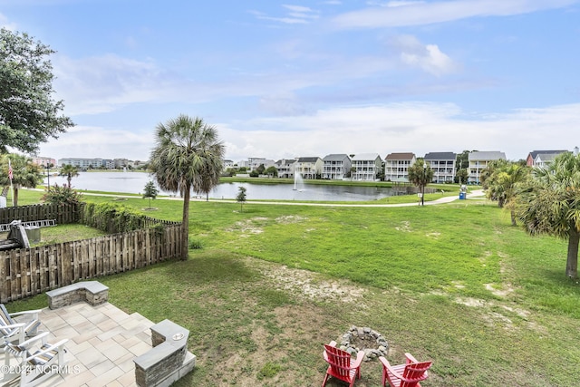 view of yard with a water view and a patio