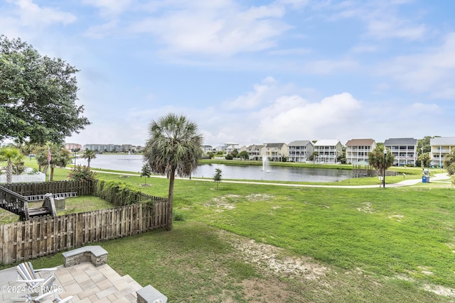 view of home's community featuring a water view and a lawn