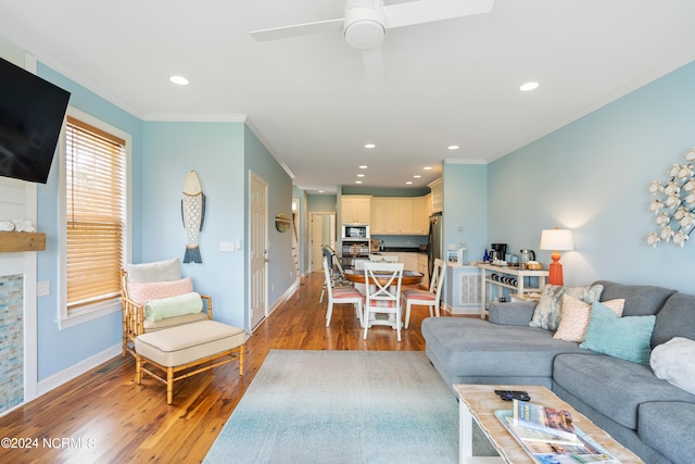 living room with ornamental molding, ceiling fan, and hardwood / wood-style floors