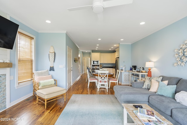 living room with ceiling fan, ornamental molding, and dark hardwood / wood-style flooring