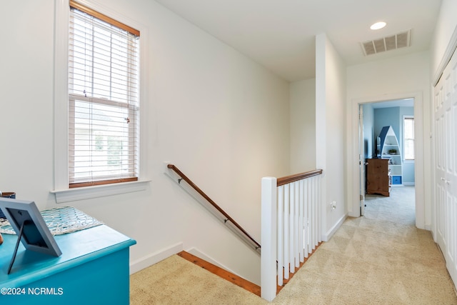 corridor with light colored carpet