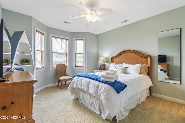 bedroom with light colored carpet and ceiling fan