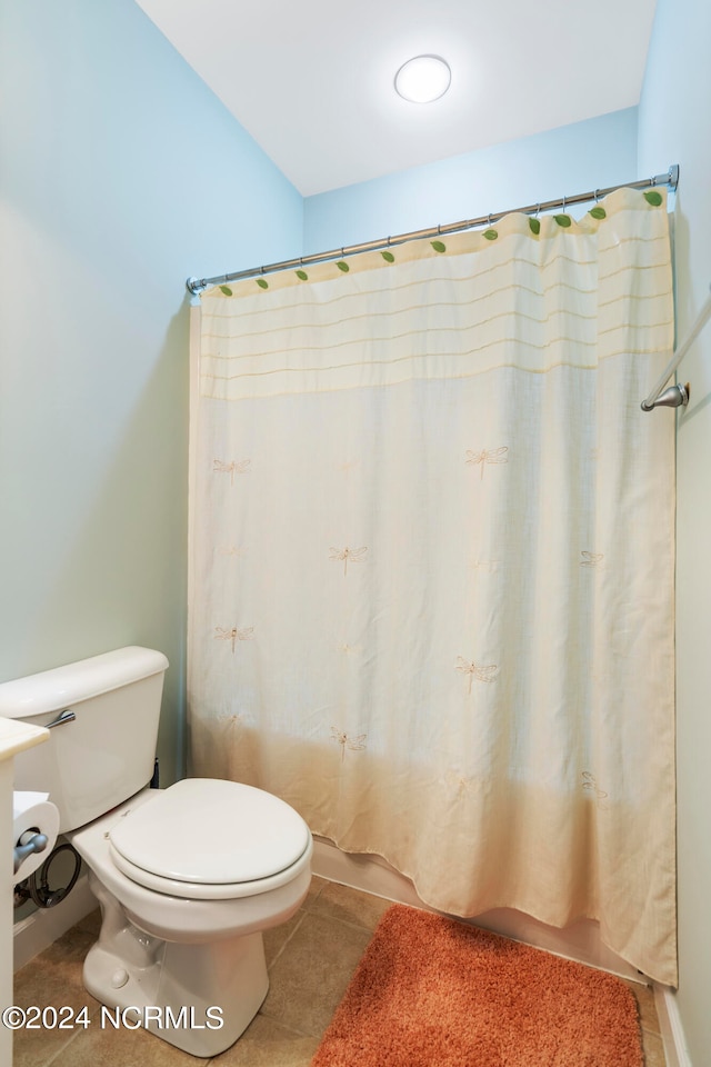 bathroom featuring toilet and tile patterned flooring