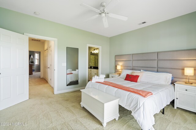 carpeted bedroom featuring connected bathroom and ceiling fan