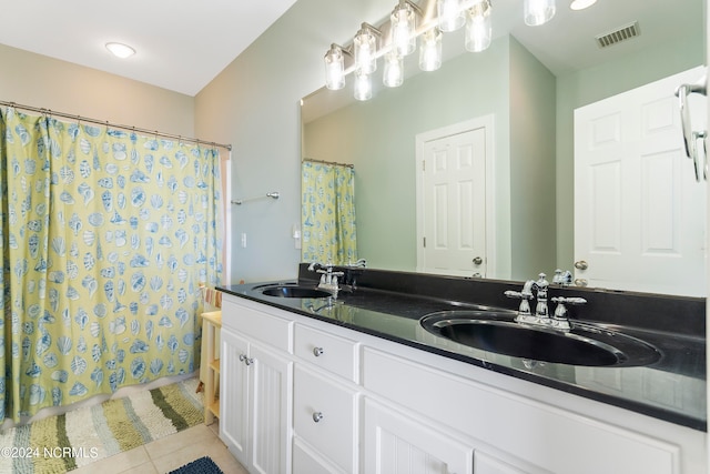 bathroom featuring tile patterned floors and dual bowl vanity